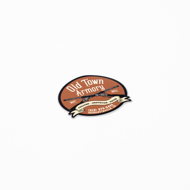 A circular sticker for "Old Town Armory" with a brown background and text detailing services in knives and ammunition, along with contact information.