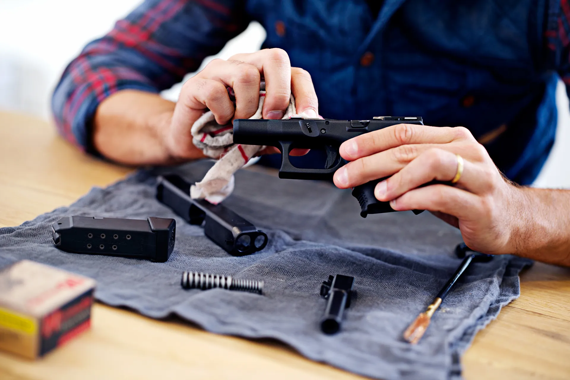 Gunsmith professionally cleaning a pistol